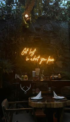 an image of a neon sign that says get lost in what you love on the wall