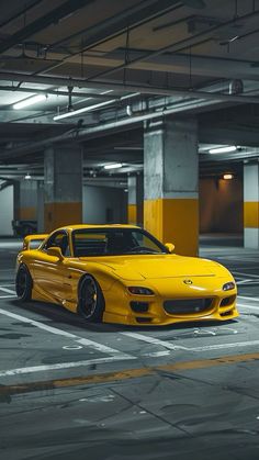 a yellow sports car parked in a parking garage