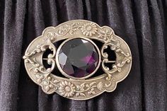 Hearts Embossed Floral Silver Tone Amethyst Color Faceted Stone Double Vintage Heart Brooch Very Detailed with 2 swirling hearts on each side that sites above a rim of flower vines. Amethyst color round Stone in a Bezel setting. The stone has a small scratch which is hard to see and feel. Sturdy C hook attached to the back. Approx. 3" L x 2" H Not signed & I am not sure of the metal. A nice piece to own! I also have other lovely New, preowned, Vintage, early vintage & Antique Jewelry listed if interested :) Thank You for Visiting :) * I Ship Out Same Day* *All questions encouraged and additional photographs will be sent upon request! Please ask all questions and thoroughly check each picture and description as ALL SALES ARE FINAL! Bijoux Art Nouveau, Filigree Jewelry, Antique Brooches, Victorian Gold, Art Nouveau Jewelry, Amethyst Color, Victorian Art, Purple Stones, Purple Glass