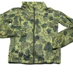 NIKE women's packable running jacket size: medium print: leaf print camo  color: Green  100% ripstop nylon Packable protection lightweight fit that packs away into a pocket  Mock neck that zips up to the chin  Pockets at chest, sides and back for multiple storage options Elastic cuffs and hem for a snug fit waterproof and breathable Underarm to underarm 20" Collar to bottom 23" R180 Military Style Spring Windbreaker For Outdoor, Military Style Windbreaker For Spring Outdoor Activities, Spring Military Style Windbreaker For Outdoor Activities, Spring Military Windbreaker For Outdoor Activities, Camouflage Windproof Windbreaker For Hiking, Nike Casual Windbreaker For Outdoor, Casual Camouflage Windbreaker For Outdoor Activities, Green Military Style Windbreaker For Spring, Military Style Green Windbreaker For Spring