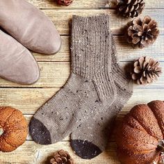 a pair of brown socks sitting on top of a wooden floor next to two bundt cakes