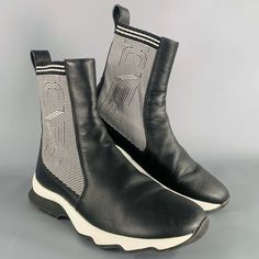 Fendi Boots In A Black Leather Featuring A Sock Style, Knit Panels With Black And White Fendi Logo, And Rubber Sole. Very Good Pre-Owned Condition. Some Creasing. Marked: 8e 663 36 Measurements: Length: 9.75 Inches Width: 3.75 Inches Height: 7 Inches Sui Generis Reference: 132900 Category: Boots More Details Brand: Fendi Gender: Female Size: 6 Color: Black Color 2: White Fabric: Leather Pattern: Knit Style: Sock Age Group: Adult Sui Generis Designer Consignment Is An Award Winning Fashion Resale Fendi Boots, Sock Style, Resale Store, Fendi Logo, Sock Boots, Knit Style, Leather Pattern, Fashion Socks, Color 2