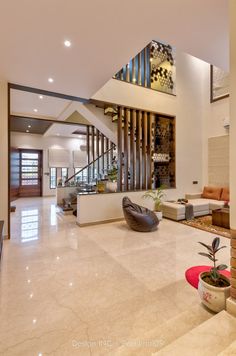 a living room filled with furniture and a staircase