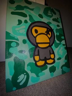 a painting of a monkey on a green camo background with black and yellow accents