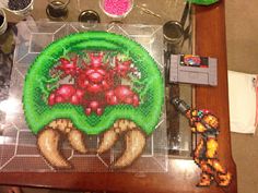 a table topped with lots of crafting supplies on top of a wooden table covered in beads