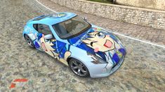 a car painted with cartoon characters is parked on the side of a road next to a brick wall