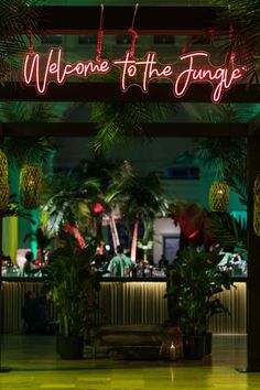 a neon sign that reads welcome to the jungle