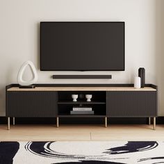 a flat screen tv sitting on top of a wooden entertainment center