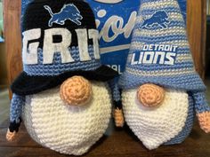 two crocheted hats on top of each other with the word detroit lions written on them