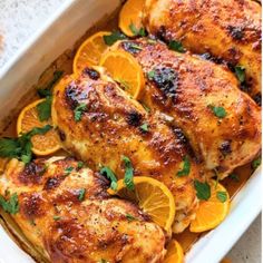 chicken with oranges and herbs in a white casserole