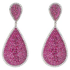 Discover the epitome of elegance with our exquisite 8.71 Carat Diamond and Ruby Fashion Earrings, a testament to meticulous craftsmanship and timeless allure. Each pair is a harmonious blend of sophistication and opulence, designed to captivate discerning tastes and elevate any ensemble to new heights of glamour. Crafted with precision, these earrings feature a stunning arrangement of brilliant-cut diamonds totaling 6.21 carats, meticulously set to maximize brilliance and sparkle with every move Luxury Pear-shaped Earrings For Formal Events, Luxury Pear-shaped Earrings For Formal Occasions, Luxury Drop Earrings With Pave Setting, Luxury Pear-shaped Bridal Earrings For Formal Occasions, Luxury Pink Diamond Earrings, Luxury Pear-shaped Cubic Zirconia Earrings, Luxury Pink Earrings With Brilliant Cut, Exquisite Earrings With Pave Setting For Evening, Luxury Pave Setting Earrings For Formal Events