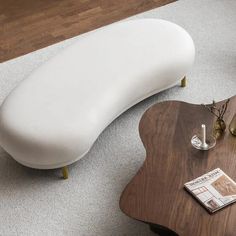 a white couch sitting on top of a wooden table