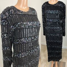 a black dress with sequins and beads on the back, next to a mannequin's head