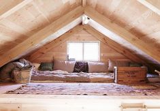 an attic bedroom with wooden walls and flooring