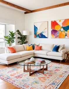 a living room with white couches and colorful pillows