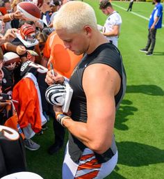 a football player signing autographs for fans