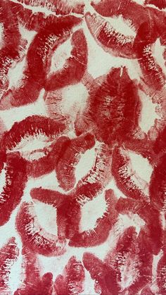 an abstract painting with red and white paint on it's surface, showing the shape of lips