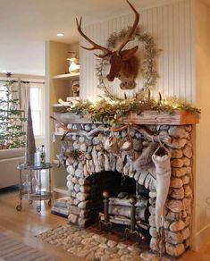 a living room with a fire place and deer heads on the wall