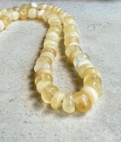 "yellow calcite candy necklace   hand knotted gemstone necklace These smooth nugget beads are light yellow Calcite gemstones, some are translucent, some are opaque and some are milky yellow. They are hand knotted with nylon cord. I handmade the sterling silver hook clasp. Total length of necklace, from end to end, is 17\".  Calcite stones measure 8-9x4-6mm. You will receive this exact necklace, arriving in a small gift box with ribbon and bow. You can enter my shop here: ladonnastudio.etsy.com" Color Stones Jewelry, Candy Necklace, Mala Beads Bracelet, Gift Box With Ribbon, Mala Bead Necklace, Candy Necklaces, Box With Ribbon, Yellow Calcite, Bronze Earrings