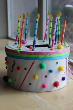 the birthday cake is decorated with colorful candles