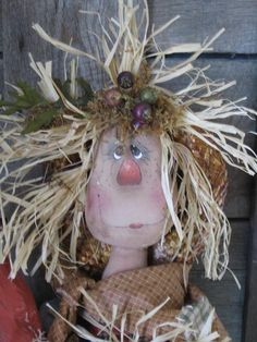 an old scarecrow doll is sitting in the hay