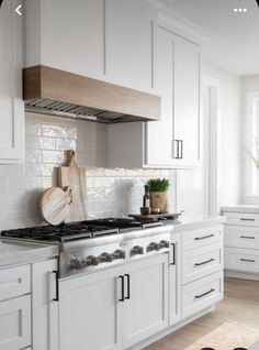 a kitchen with white cabinets and an oven