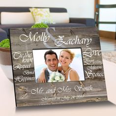 a personalized wooden frame with the names of two people on it and an image of a bride and groom