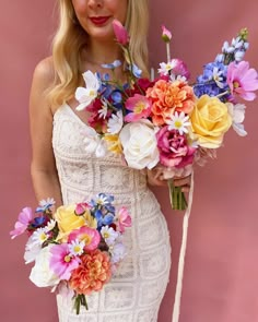 a woman in a white dress holding a bouquet of flowers