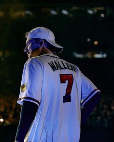 a baseball player is standing with his hands on his hips and looking at the crowd