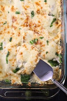 a casserole dish with cheese and spinach