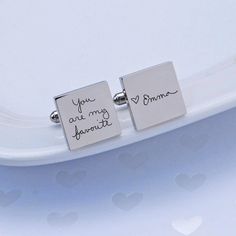 Cufflinks are a lovely gift, engraved cufflinks are even better, but customizing them with your own handwriting? That's genius-level gift giving! Look like a thoughtful genius when you present your loved one with these custom engraved cufflinks. CUSTOM ENGRAVING: CUFFLINK 1: [Message part 1 - 25 character max] CUFFLINK 2: [Message part 2 - 25 character max] DETAILS: MATERIAL: stainless steel SHAPES: round or square FINISHES: gold, gunmetal, rose gold, stainless steel DIMENSIONS: 5/8 inch HOW TO Rose Gold Square, Engraved Handwriting, Engraved Cufflinks, Custom Cufflinks, Handwriting Jewelry, Personalized Cufflinks, Gold Cufflinks, Our Wedding Day, Cuff Links