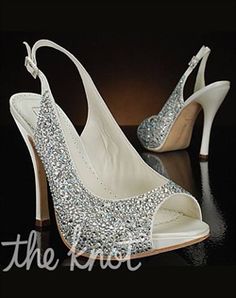 a pair of white high heeled shoes with silver sequins