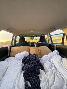 the interior of a vehicle with an unmade bed