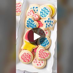 decorated cookies in the shape of teddy bears on a white platter with an animated video