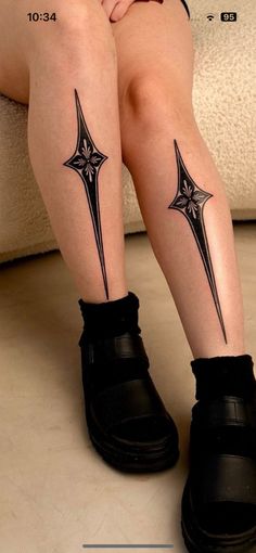 a woman's legs with cross tattoos on them