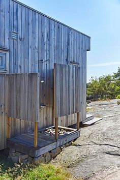 a small wooden building sitting on the side of a road