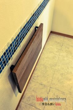 a bathroom with tiled walls and flooring next to a wall mounted toilet paper dispenser