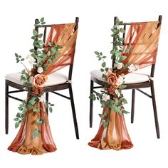 two chairs decorated with flowers and greenery