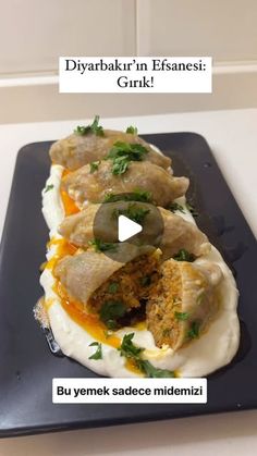 a black plate topped with food on top of a counter