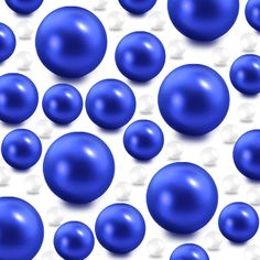 many blue balls are scattered together on a white surface