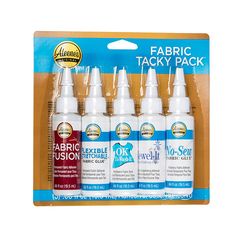 four bottles of fabric tacky pack in a cardboard package with the packaging on it