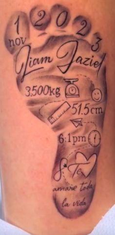 a tattoo on the back of a woman's leg with a hand and birth date