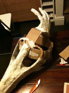 an animal's head is made out of paper and cardboard with scissors next to it