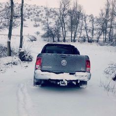 the back end of a truck driving through snow