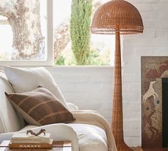 a living room with a couch, table and lamp in it's centerpiece