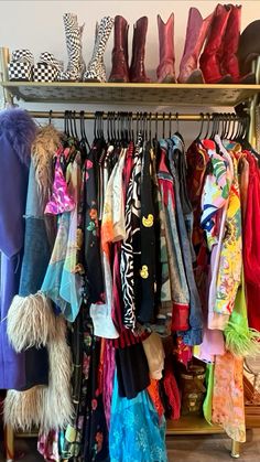 a rack full of different colored shoes and scarves hanging on it's sides