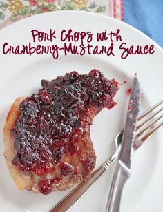 a white plate topped with a piece of pie covered in cranberry sauce