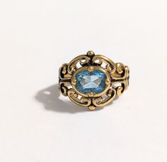 Vintage "Versailles" ring Antique gold-toned  filigree ring with a Light Blue Colored Crystal Size 5 marked BY This item is in great, like new condition Versailles Ring, Topaz Cocktail Ring, Gold Skies, Ring Antique, Rhinestone Ring, Filigree Ring, Multi Stone Ring, Blue Rhinestones, Multi Stone