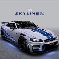 a white and blue sports car is shown in front of a sky line sign that says skyline