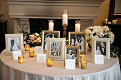 a table topped with pictures and candles next to flowers